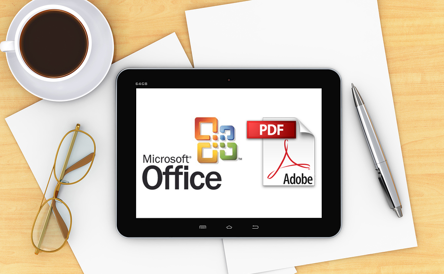 Destop with office items, coffee and a computer device with Microsoft Office and Abode logos