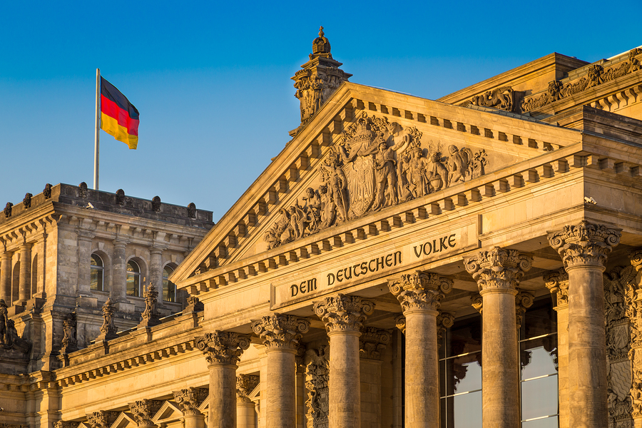 Reichstag building in Berlin, Germany with German flag symbolizing German translations services