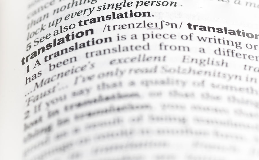 An image of the word translation highlighted in a dictionary symbolizing language translation services.